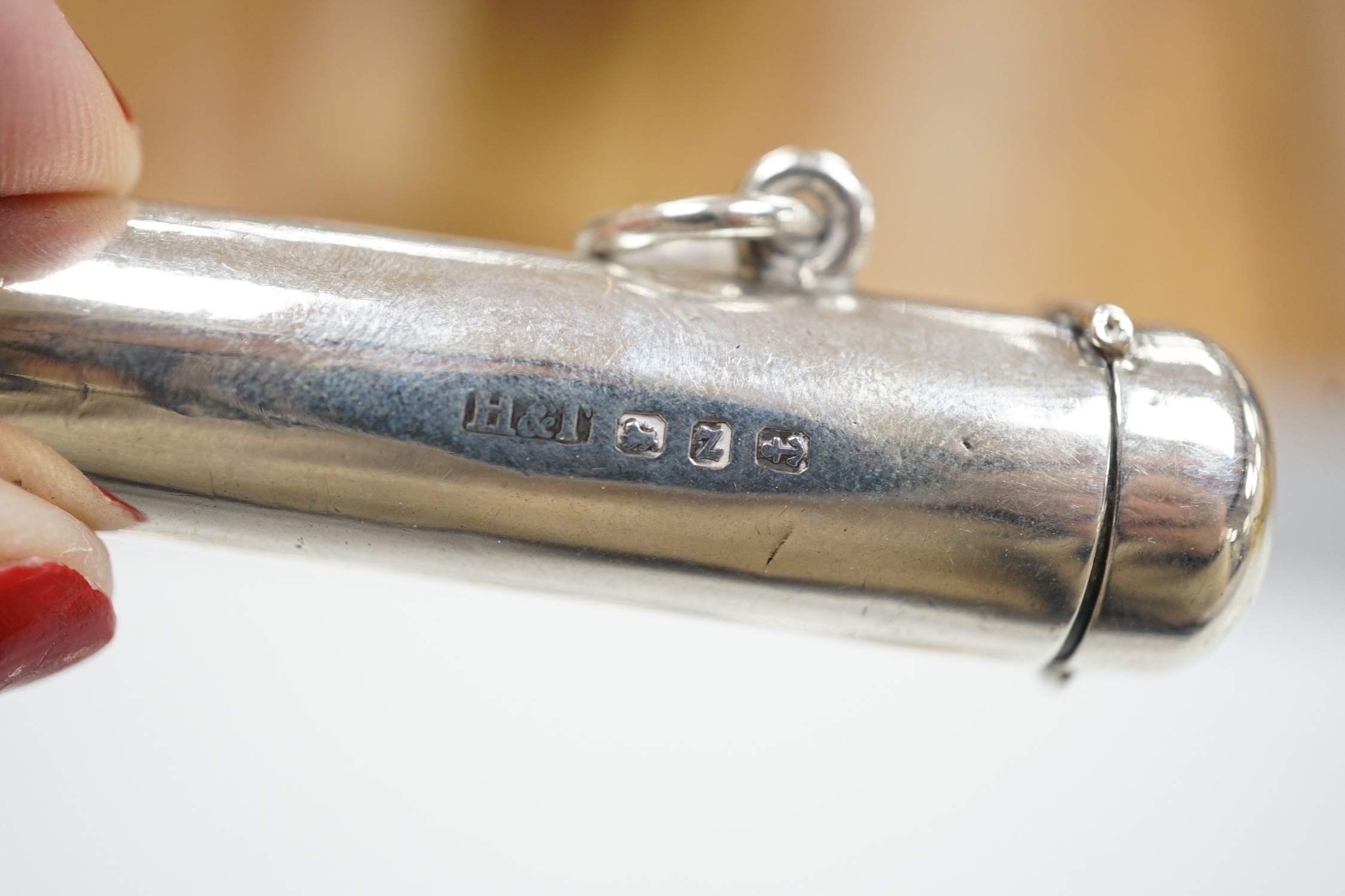 A late Victorian silver caddy spoon, 92mm, a silver cigarette holder, toothbrush, two trinket boxes and a brass seal.